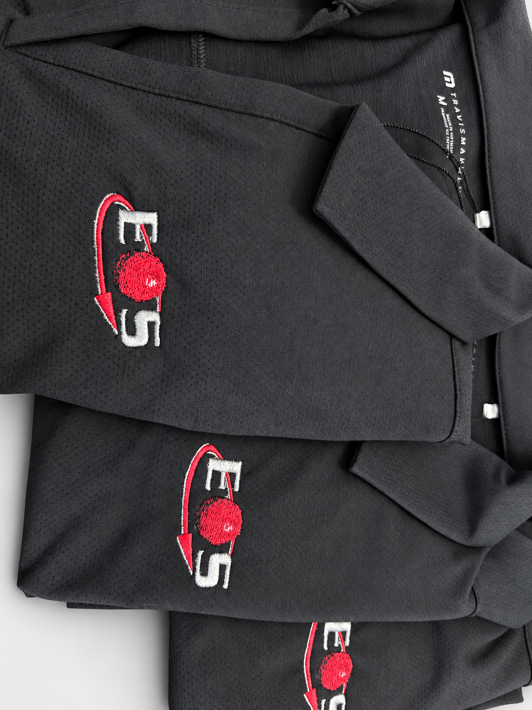 Folded black polos with upright red and white embroidered logos